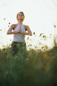 Woman Meditating in Field